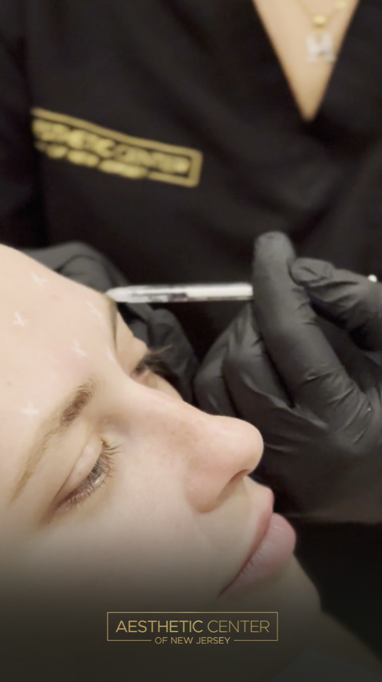 Woman receiving Daxxify anti-wrinkle injections for forehead lines.