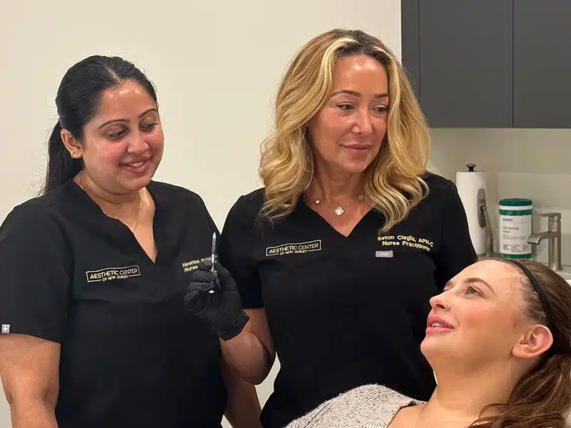 Two nurse practitioner injectors giving a patient a consultation before botox and filler.